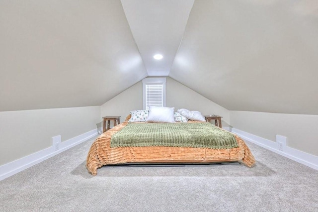 carpeted bedroom with vaulted ceiling