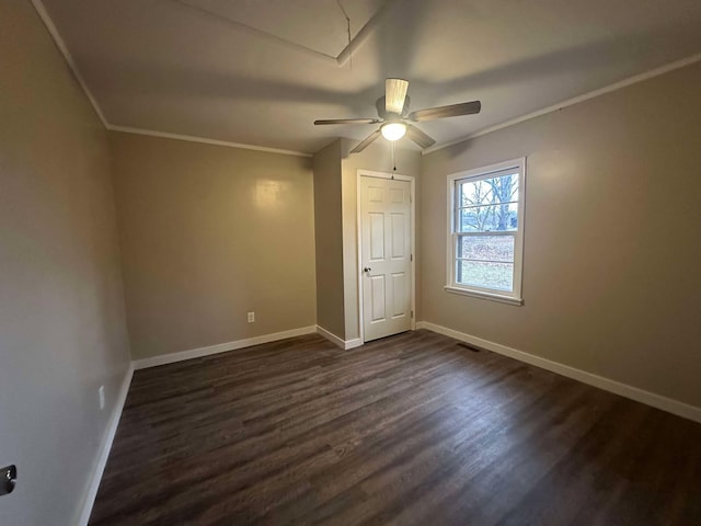 unfurnished bedroom featuring crown molding, dark hardwood / wood-style floors, and ceiling fan