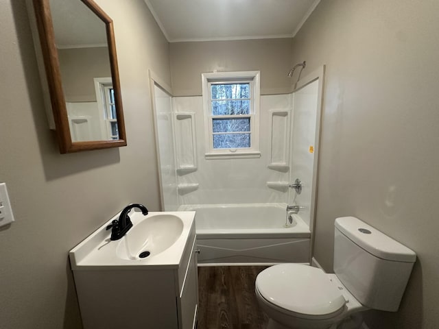 full bathroom featuring toilet,  shower combination, ornamental molding, vanity, and hardwood / wood-style floors