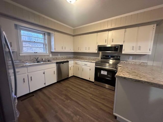 kitchen featuring white cabinetry, sink, ornamental molding, and stainless steel appliances