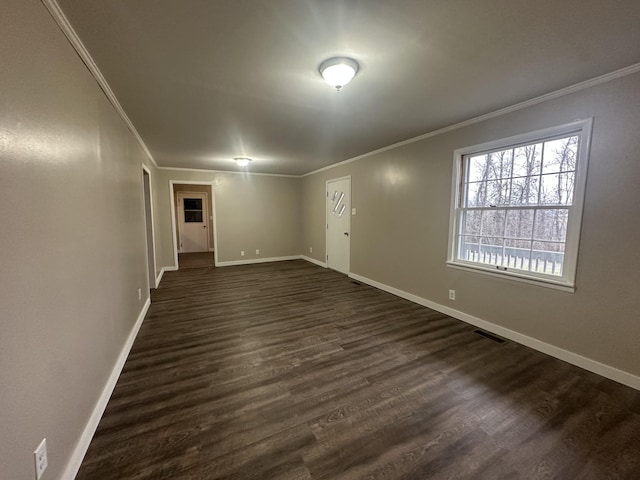 empty room with crown molding and dark hardwood / wood-style floors