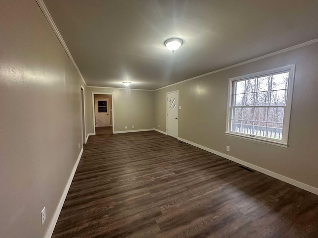 unfurnished room with dark hardwood / wood-style flooring and ornamental molding