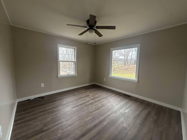 empty room featuring ceiling fan, ornamental molding, and dark hardwood / wood-style floors