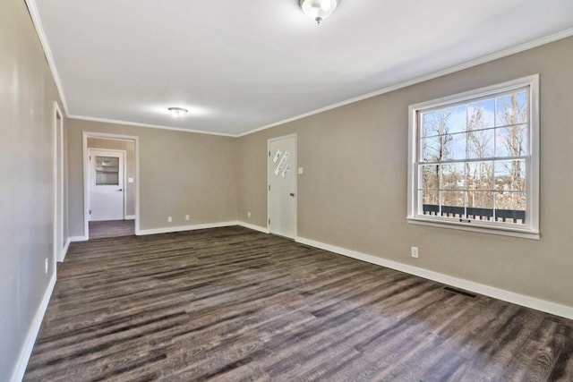 unfurnished room with ornamental molding, dark wood finished floors, and baseboards