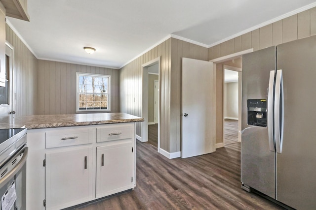 kitchen featuring ornamental molding, stainless steel fridge, dark wood finished floors, and white cabinets