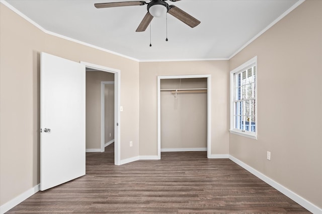 unfurnished bedroom with dark wood-style floors, ornamental molding, and baseboards