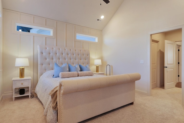 bedroom with light carpet, high vaulted ceiling, and ceiling fan