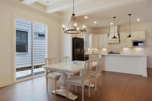 dining area with hardwood / wood-style flooring, a notable chandelier, and beam ceiling