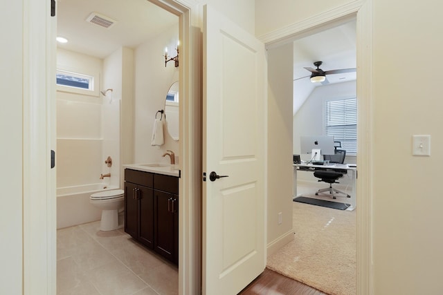 full bathroom featuring toilet, tub / shower combination, vaulted ceiling, vanity, and ceiling fan