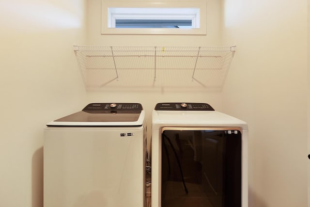 washroom featuring washing machine and dryer