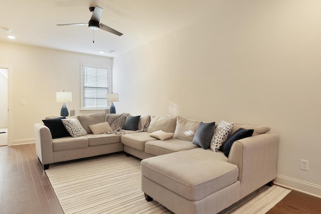 living room with ceiling fan and light hardwood / wood-style flooring