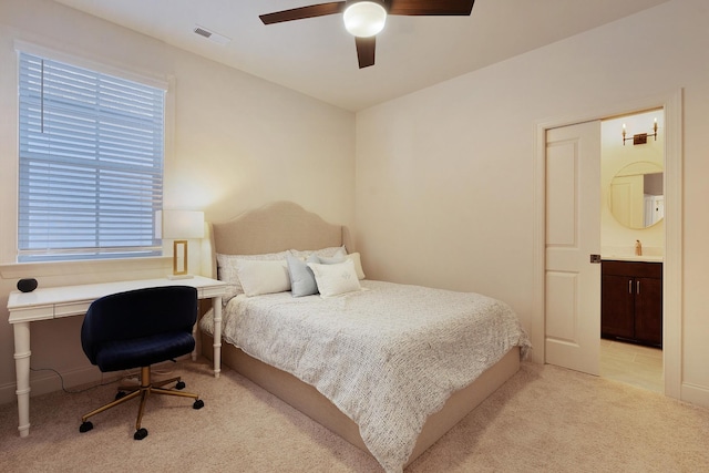 carpeted bedroom with ceiling fan and ensuite bathroom