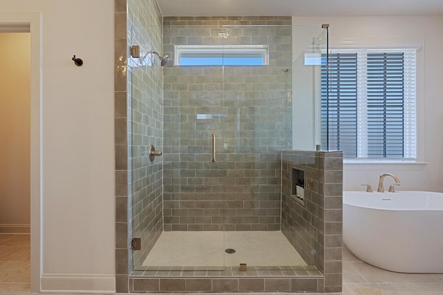 bathroom with tile patterned flooring and separate shower and tub