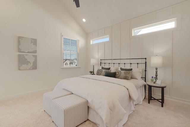 bedroom with ceiling fan, high vaulted ceiling, and light carpet