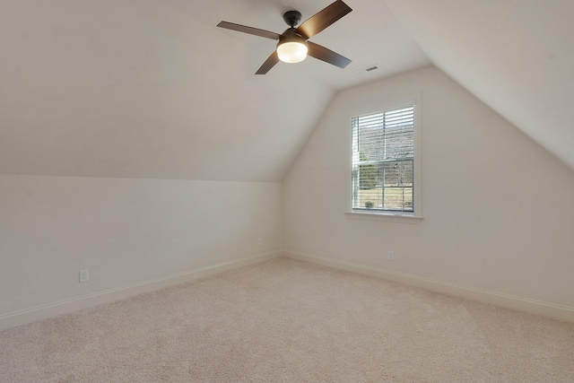 additional living space featuring light carpet, lofted ceiling, and ceiling fan