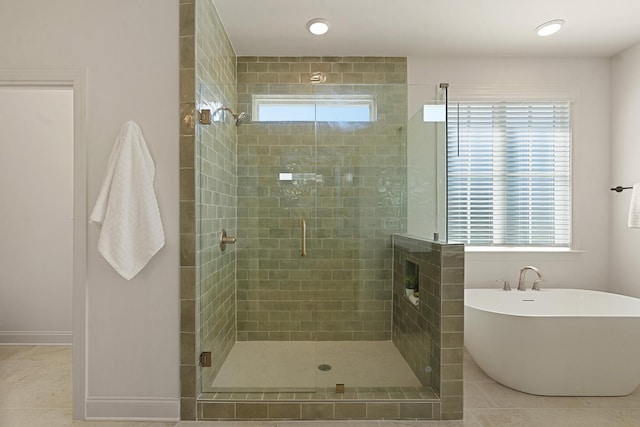 bathroom with tile patterned floors, shower with separate bathtub, and a healthy amount of sunlight