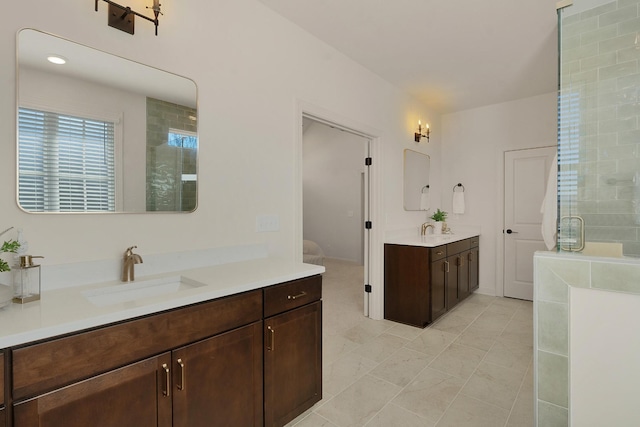 bathroom with vanity and a shower with door