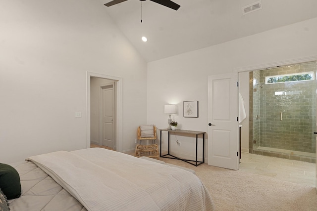 bedroom with ceiling fan, high vaulted ceiling, light carpet, and connected bathroom