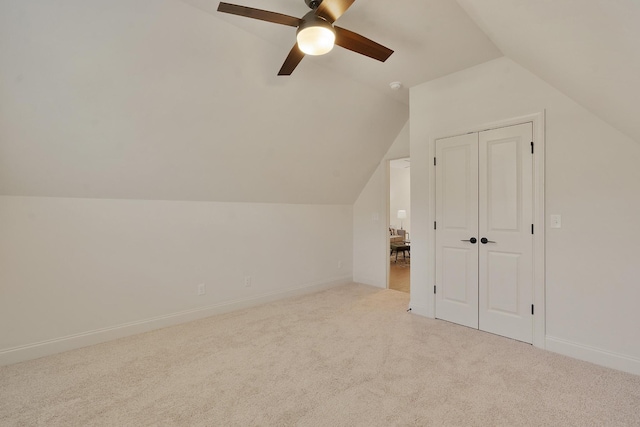 bonus room featuring light carpet, lofted ceiling, and ceiling fan