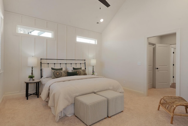 bedroom featuring ceiling fan, high vaulted ceiling, and light colored carpet