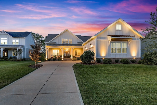 view of front of house featuring covered porch and a lawn