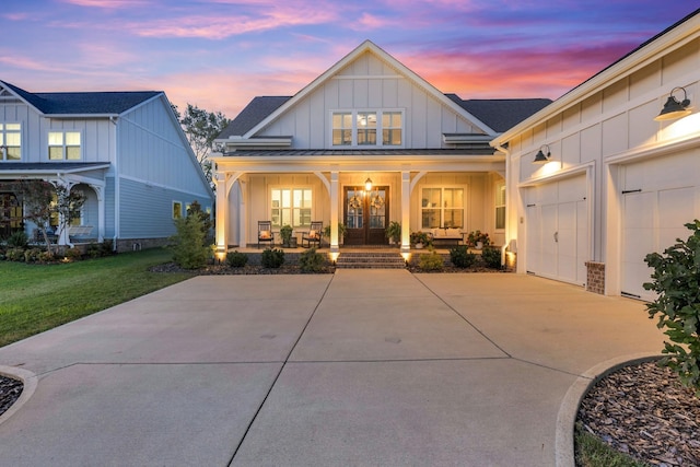 view of front facade with a garage, a yard, and covered porch