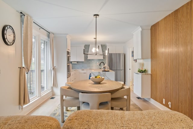 dining room featuring an inviting chandelier and sink