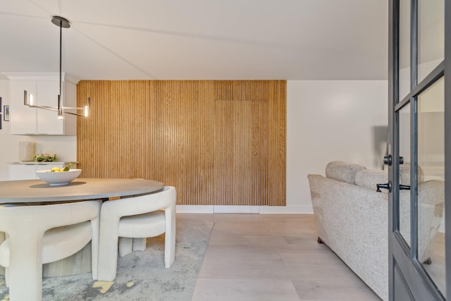 dining area featuring wood walls