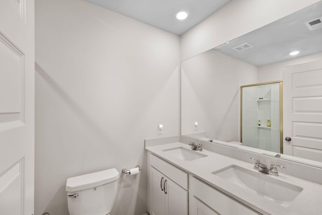 bathroom with vanity, toilet, and an enclosed shower