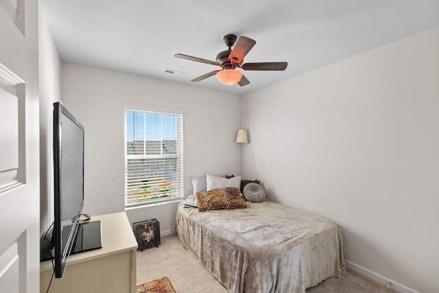 bedroom featuring light colored carpet and ceiling fan