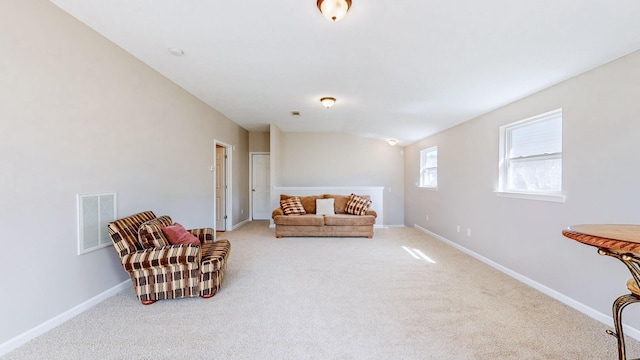 sitting room featuring lofted ceiling and carpet floors