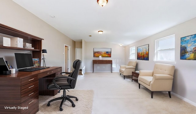 home office with light carpet and vaulted ceiling