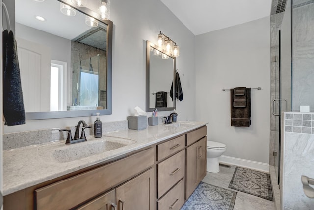 bathroom featuring a shower with door, vanity, tile patterned flooring, and toilet