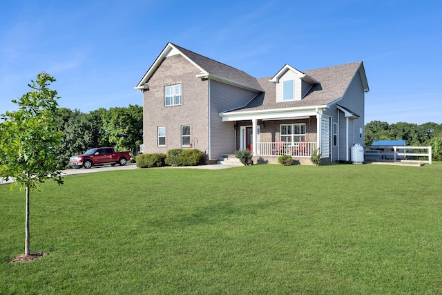 view of front facade with a front lawn and covered porch