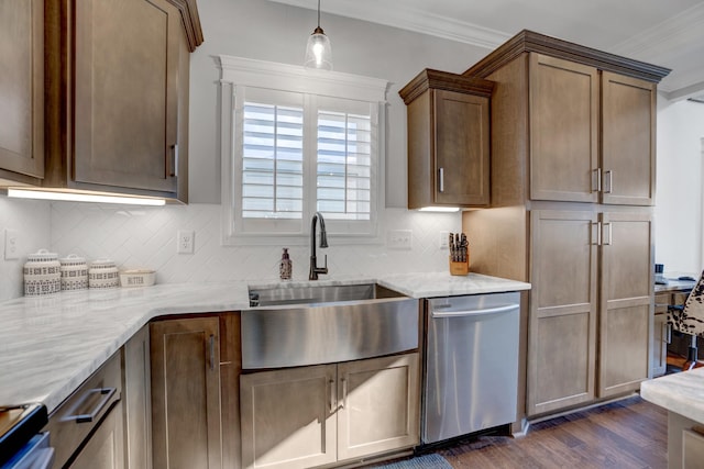 kitchen featuring dishwasher, sink, backsplash, and light stone counters