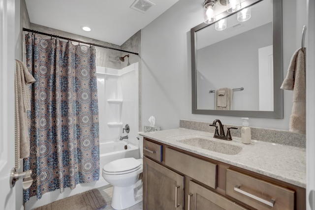 full bathroom with vanity, shower / bath combo, and toilet