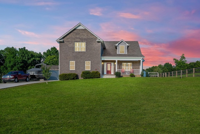 view of front of house featuring a yard and covered porch