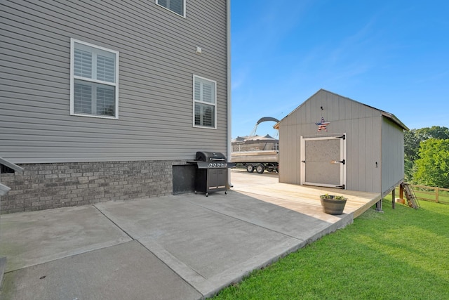 view of patio featuring area for grilling and a storage shed