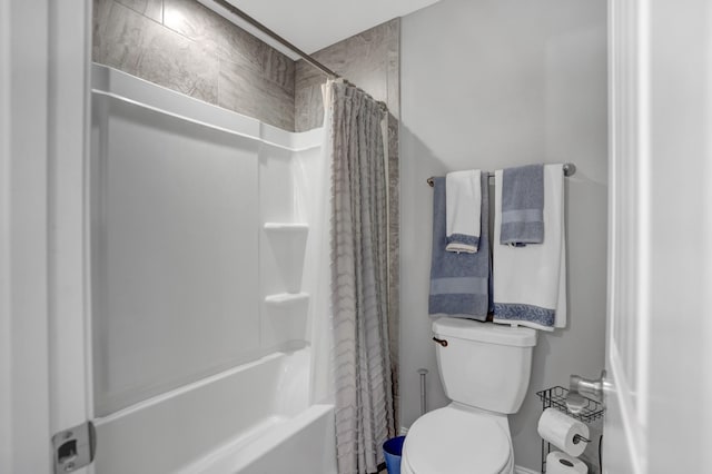 bathroom featuring toilet and shower / tub combo