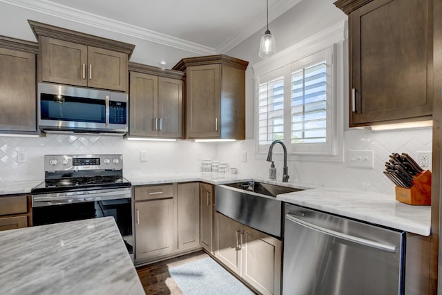 kitchen with appliances with stainless steel finishes, sink, backsplash, and light stone counters