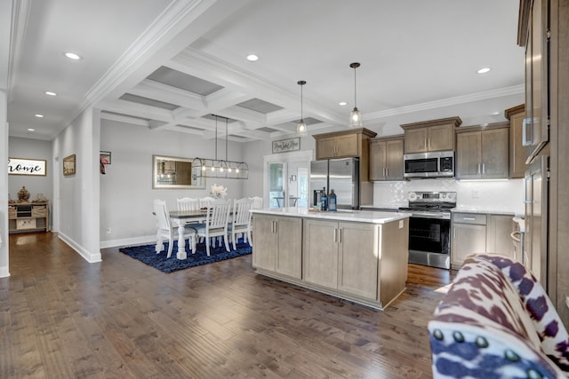 kitchen with appliances with stainless steel finishes, hanging light fixtures, coffered ceiling, a center island with sink, and beamed ceiling