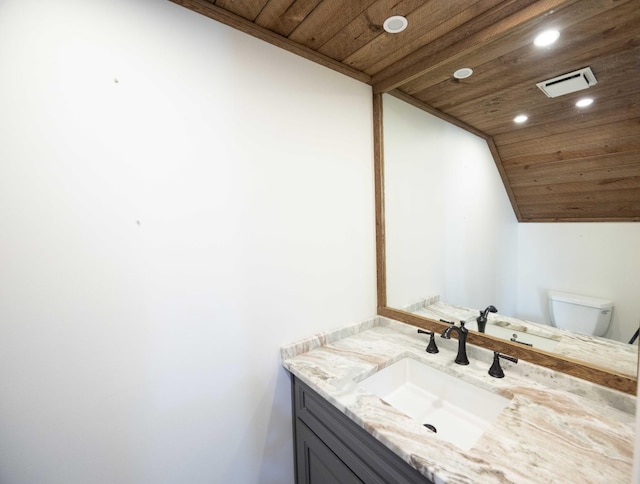 bathroom featuring vanity, toilet, vaulted ceiling, and wooden ceiling