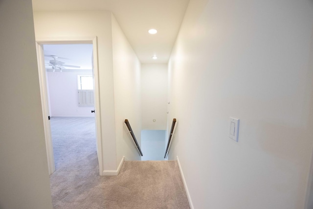 hallway featuring light colored carpet