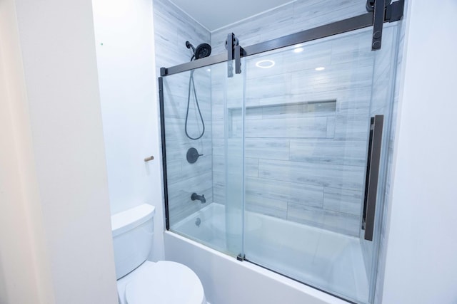 bathroom with enclosed tub / shower combo and toilet