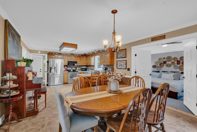 dining area with an inviting chandelier and ornamental molding