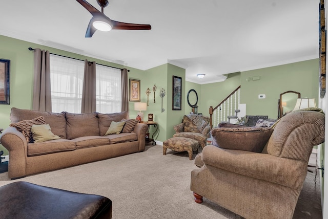 carpeted living room featuring ornamental molding and ceiling fan