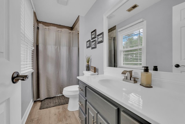 bathroom featuring hardwood / wood-style flooring, vanity, toilet, and a shower with curtain