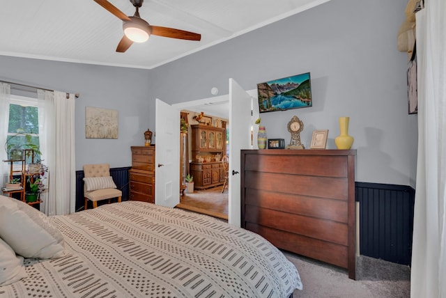 bedroom with crown molding, light carpet, and ceiling fan