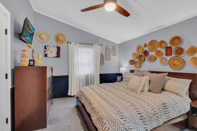 carpeted bedroom featuring crown molding, lofted ceiling, and ceiling fan