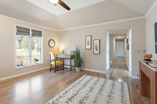 interior space with ceiling fan, ornamental molding, lofted ceiling, and light hardwood / wood-style floors